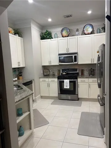 a kitchen with a stove a sink and a refrigerator