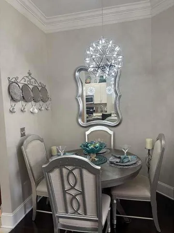 a view of a dining room with furniture and chandelier