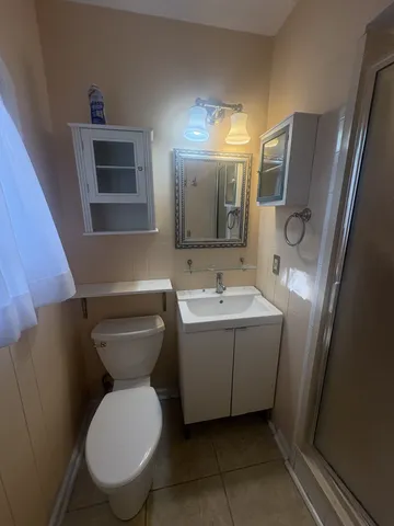 a bathroom with a toilet sink and mirror
