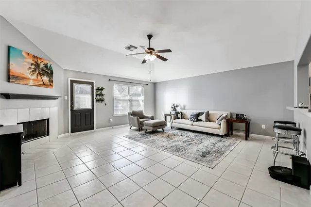 a living room with furniture and a fireplace