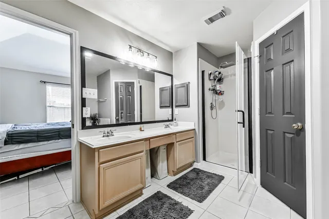 a bathroom with a tub sink and mirror