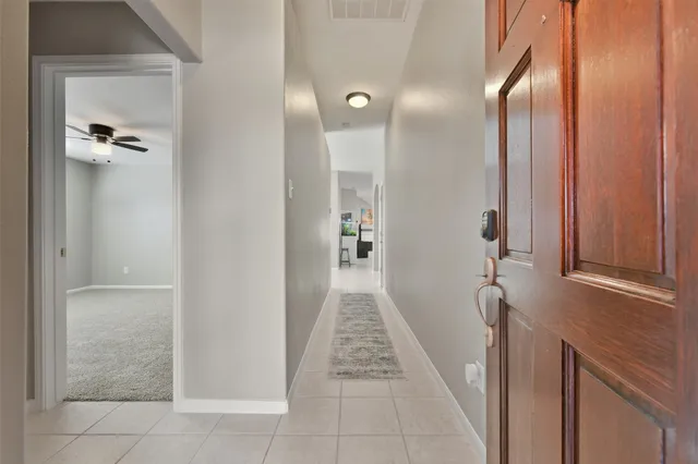 a view of a hallway with wooden shelves