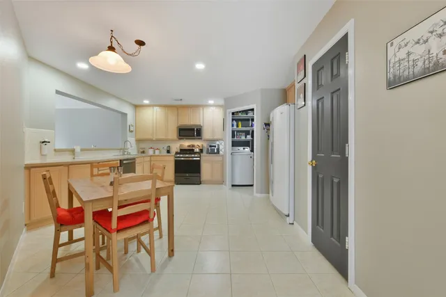 a kitchen with stainless steel appliances granite countertop a refrigerator and a stove top oven