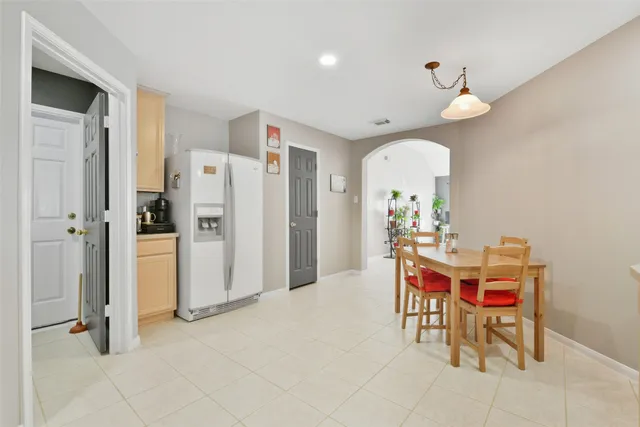 a view of a dining room with furniture and a chandelier