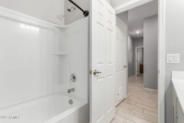 a room that has a bed and a wooden floor