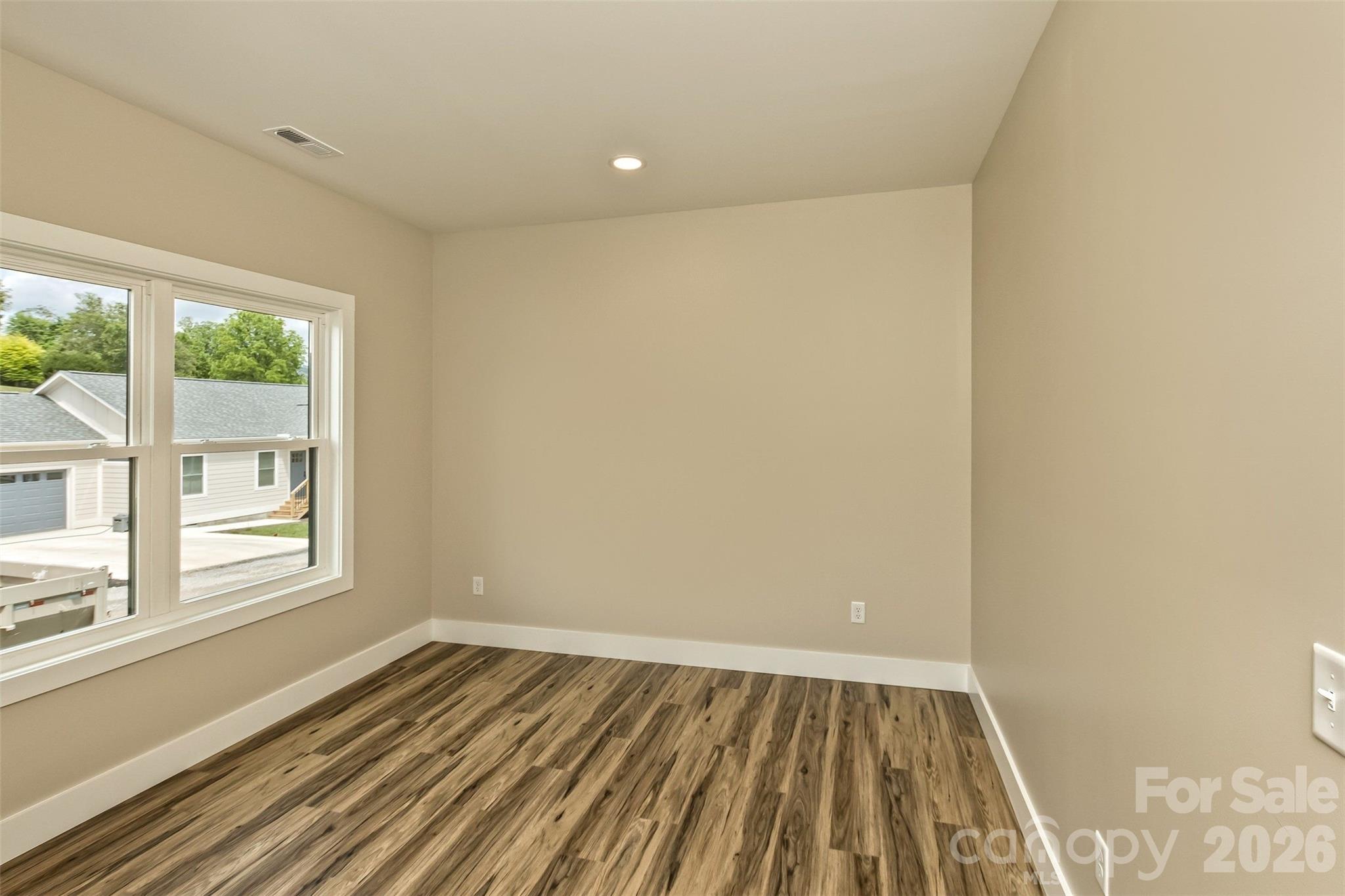 112 Peyton Elaine Road Clyde, NC 28721 - Photo 15 of 35 an empty room with wooden floor and windows