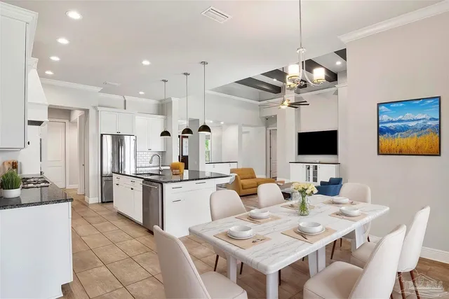 a kitchen with stainless steel appliances granite countertop a sink stove and cabinets
