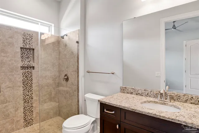 a bathroom with a granite countertop tub sink and mirror