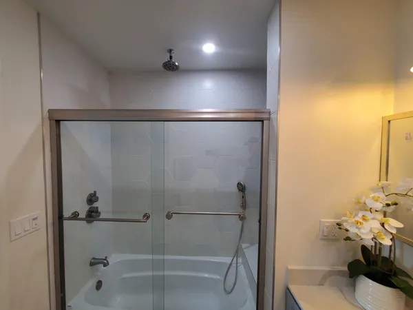 a bathroom with a shower and a tub