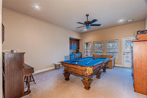 a view of an empty room with furniture and a kitchen
