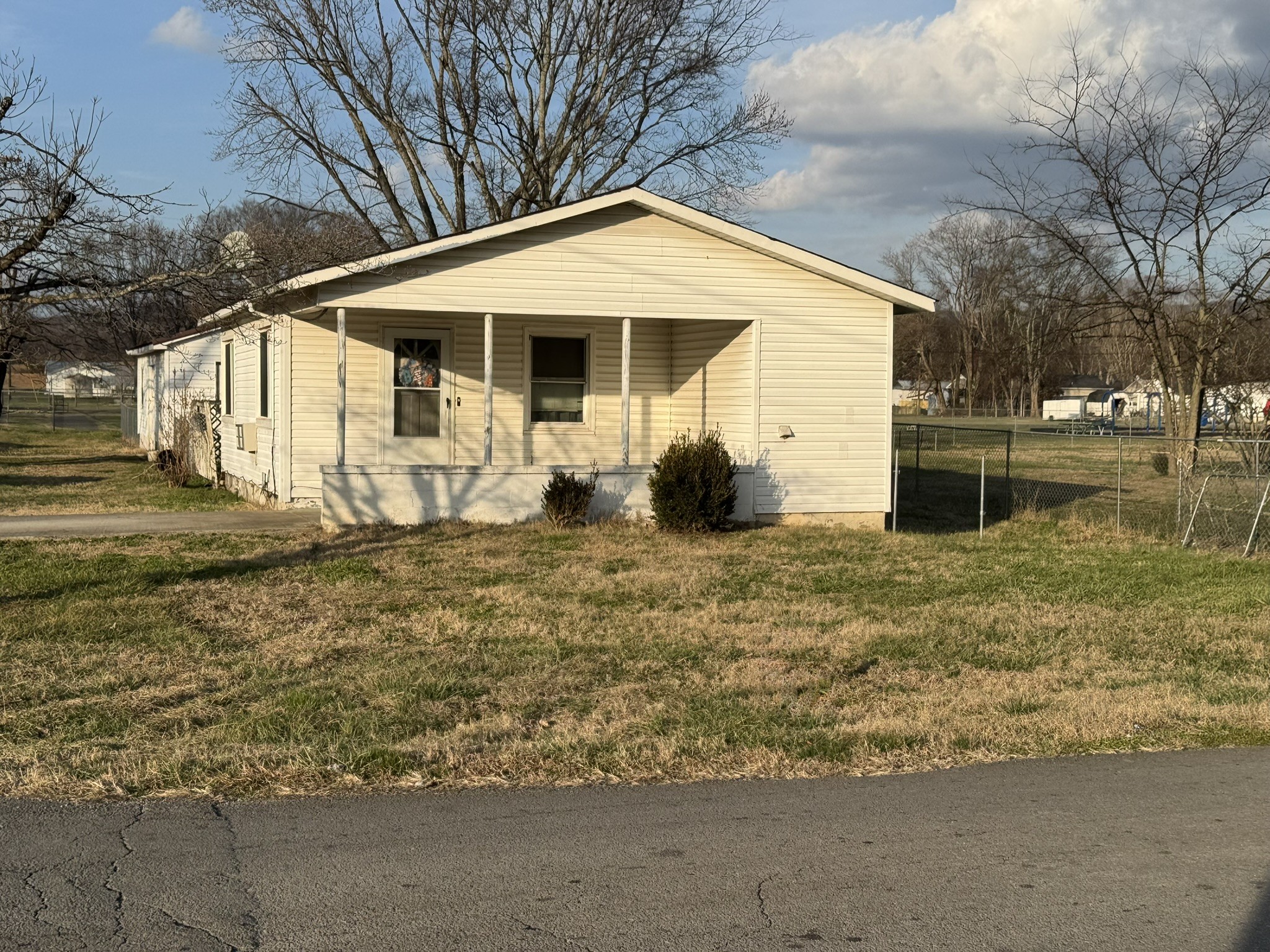 212 College Street North Cowan, TN 37318 - Photo 1 of 11 a front view of a house with garden