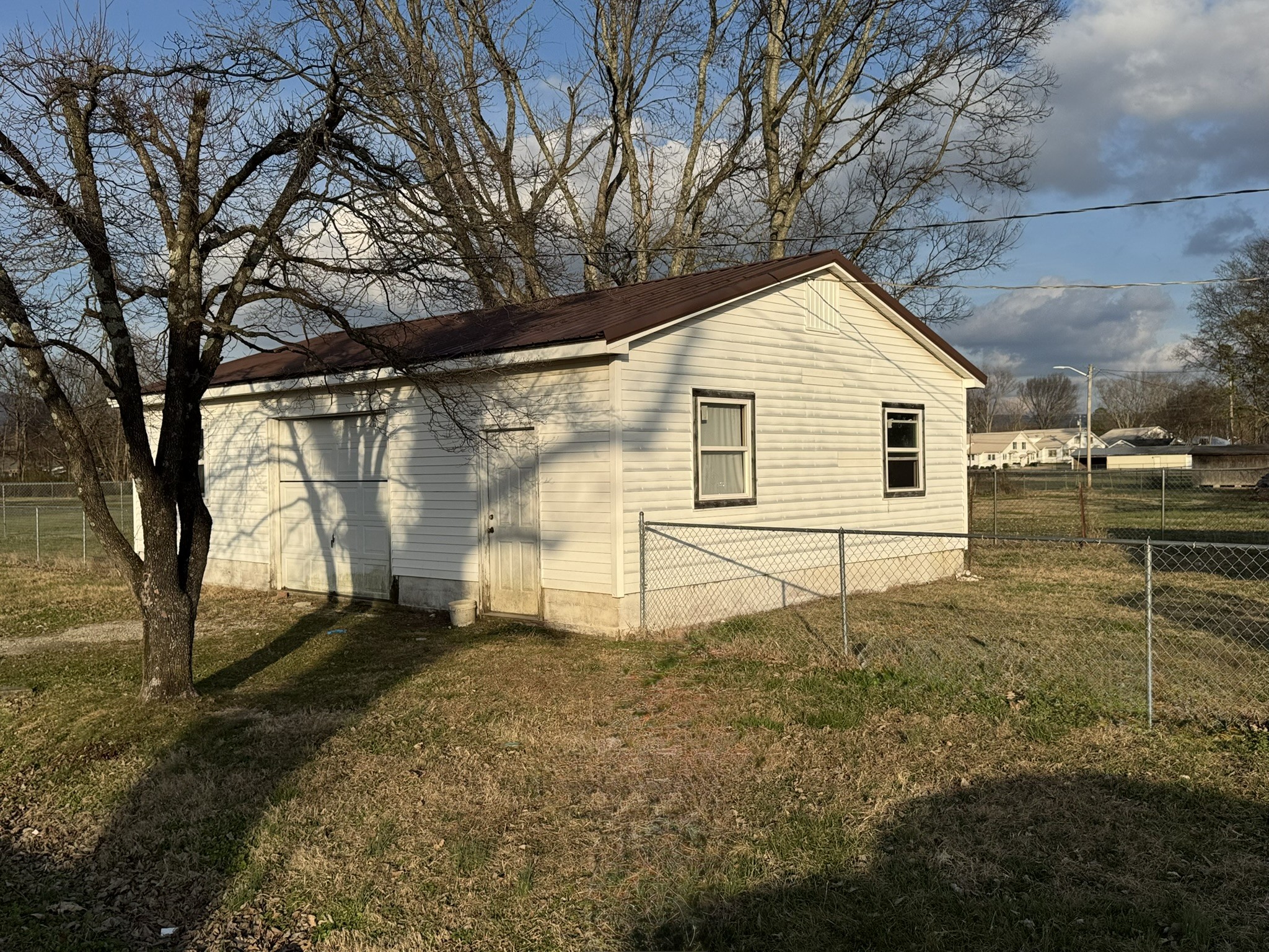 212 College Street North Cowan, TN 37318 - Photo 8 of 11 a view of a house with a yard