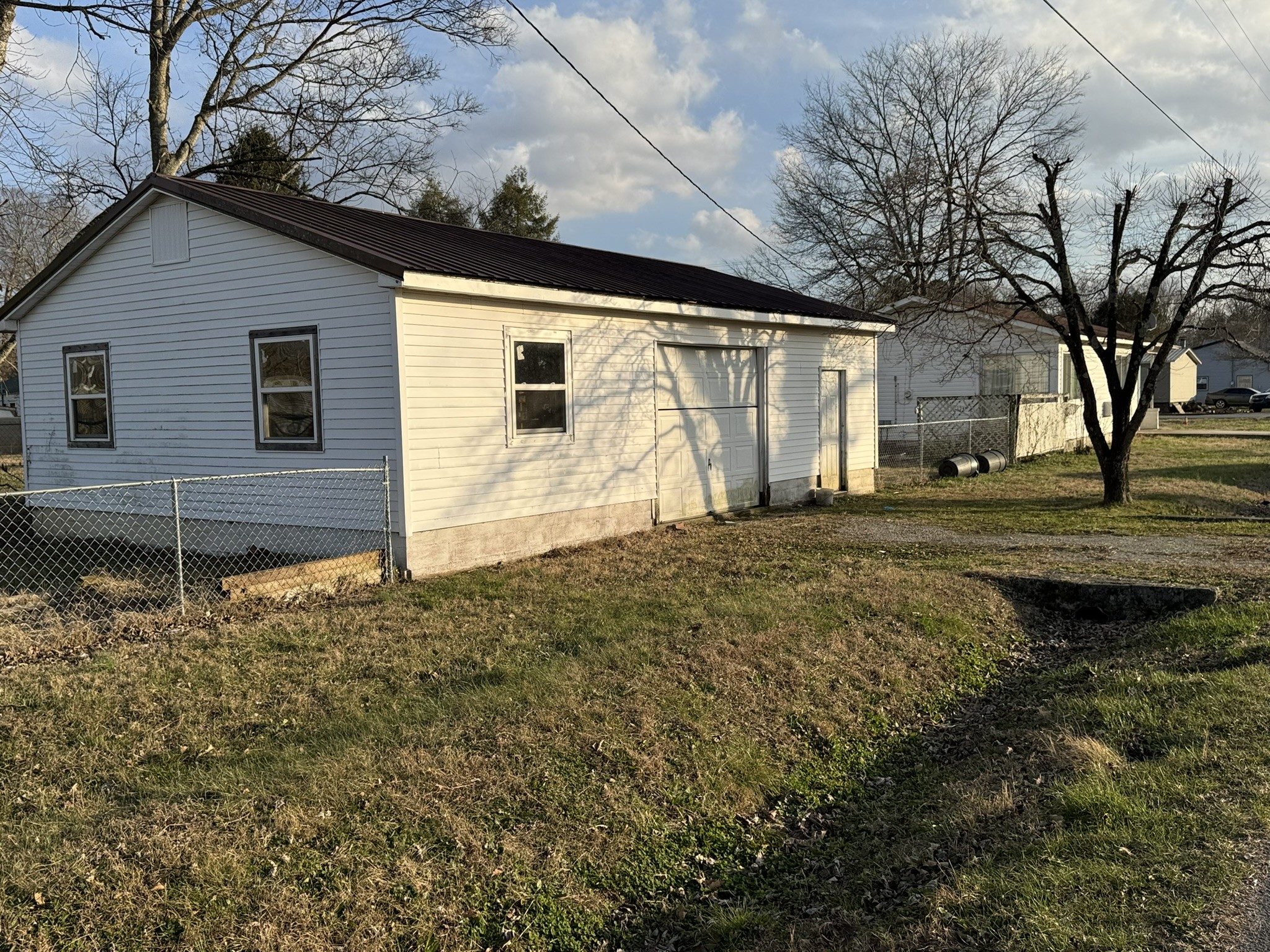 212 College Street North Cowan, TN 37318 - Photo 9 of 11 a backyard of a house with large trees
