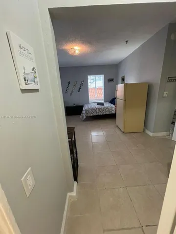 a view of room with window and furniture