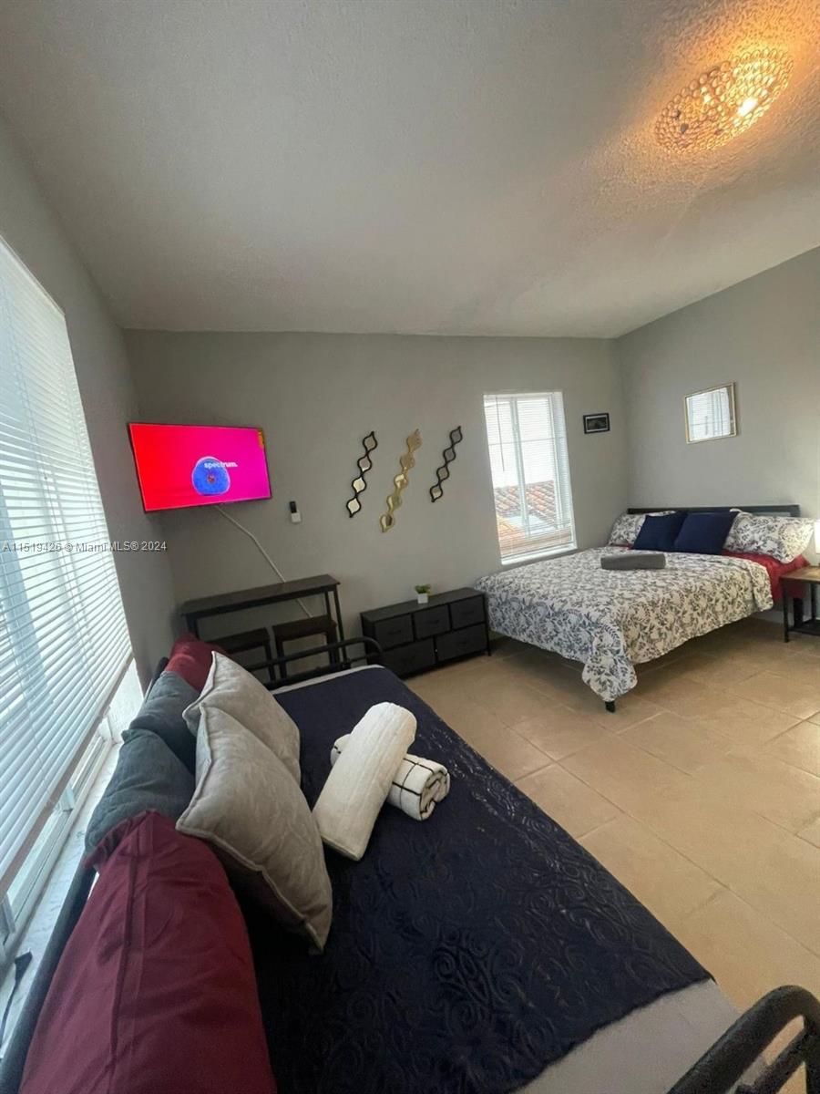 Mid Beach Miami Beach, FL 33140 - Photo 12 of 25 a living room with furniture and a lamp