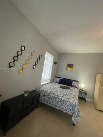 a bedroom with a bed and dresser
