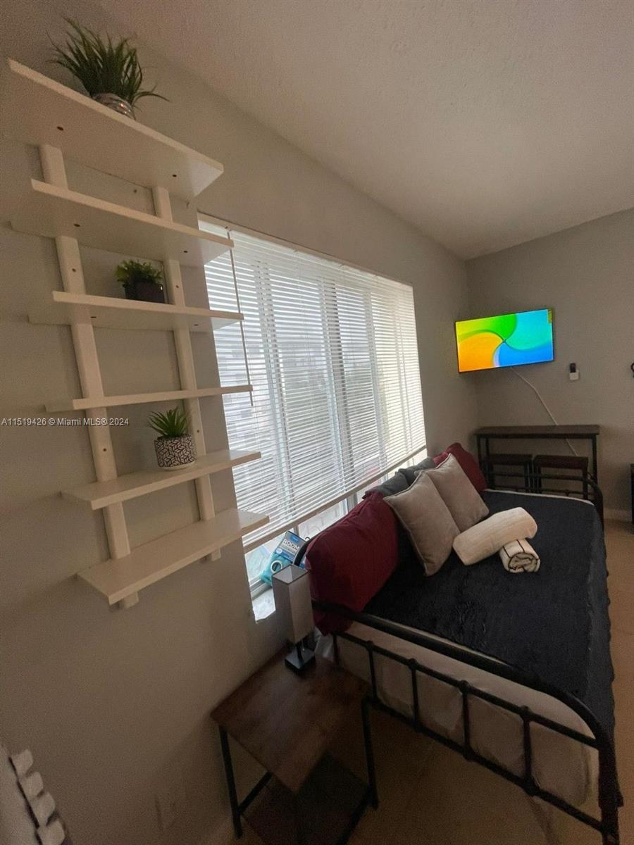 Mid Beach Miami Beach, FL 33140 - Photo 15 of 25 a living room with furniture and a window