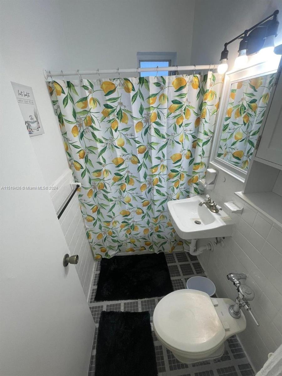 Mid Beach Miami Beach, FL 33140 - Photo 18 of 25 a bathroom with a sink and mirror