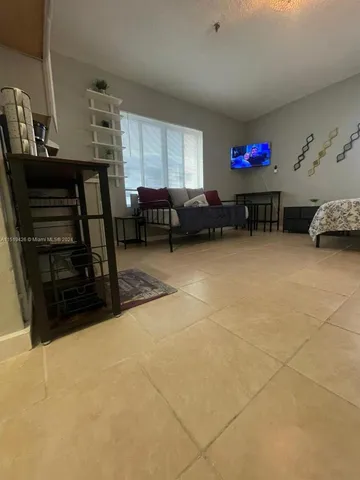 a garage with a chair and white walls