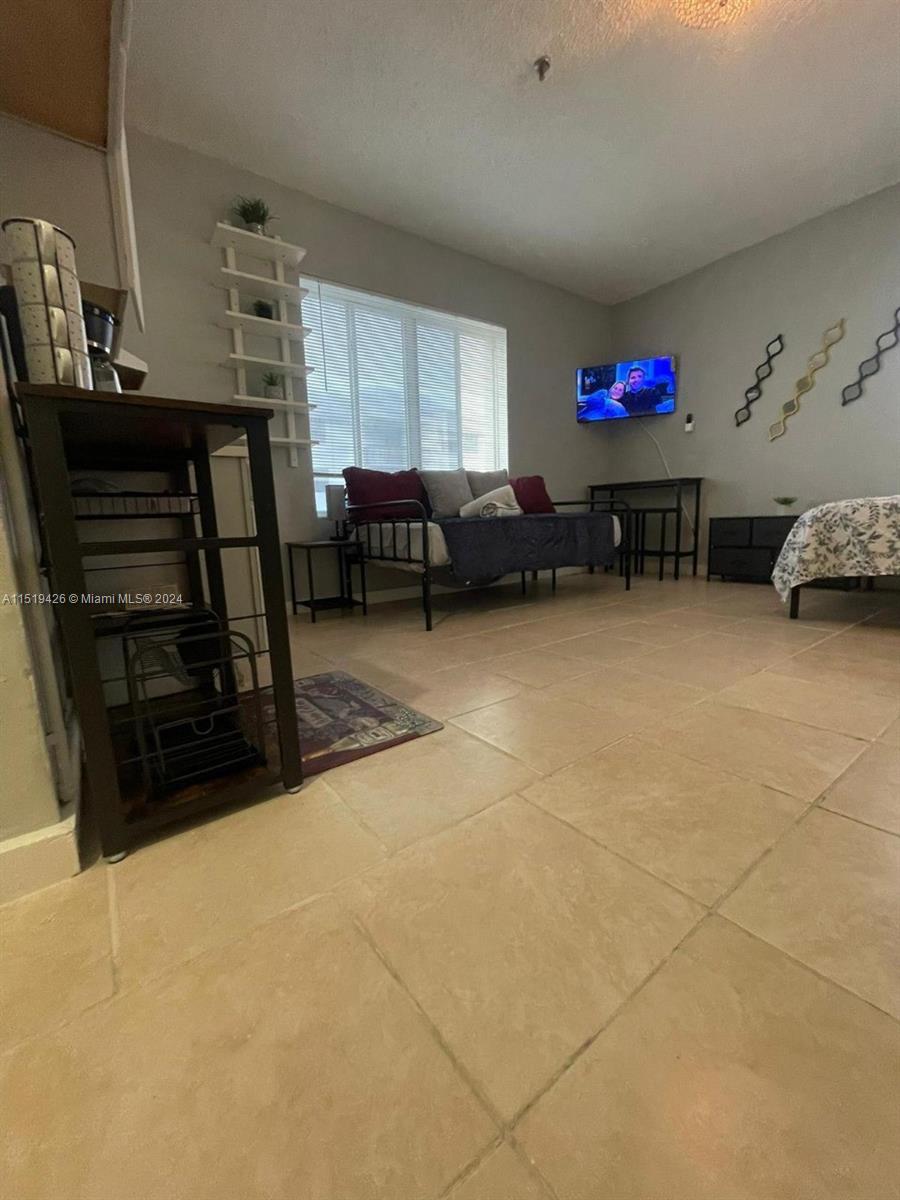 Mid Beach Miami Beach, FL 33140 - Photo 19 of 25 a garage with a chair and white walls