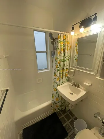 a bathroom with a sink mirror toilet and bathtub