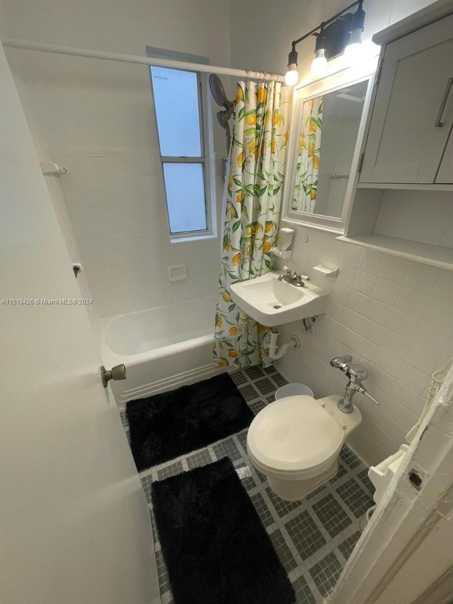 Mid Beach Miami Beach, FL 33140 - Photo 25 of 25 a bathroom with a sink a toilet a mirror and shower