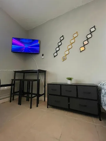 a view of a room with furniture and wooden floor