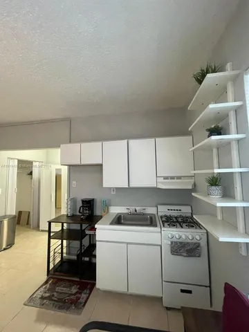 a kitchen with a cabinets and white appliances