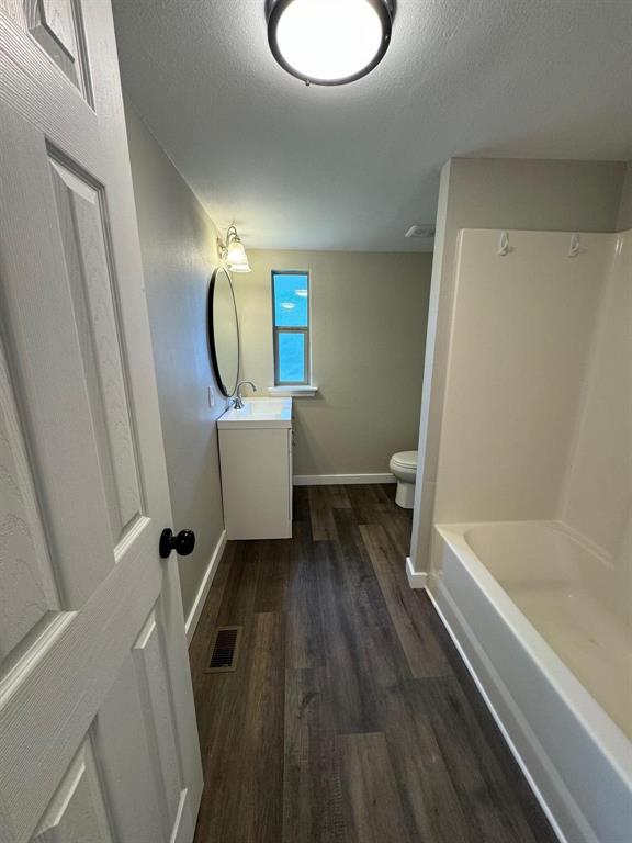 1201 North Rusk Street Weatherford, TX 76086 - Photo 11 of 32 a bathroom with a sink a toilet and bathtub