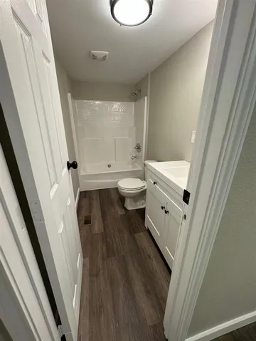 a bathroom with a toilet sink and a mirror