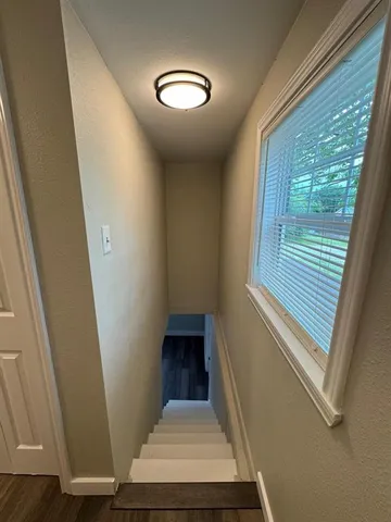 a view of a room with wooden floor and stairs