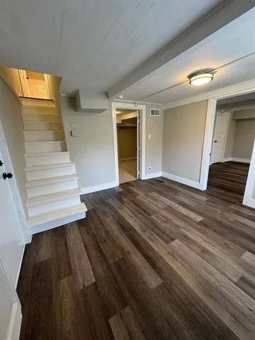 a view of a room with wooden floor and stairs