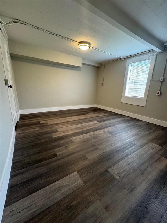 1201 North Rusk Street Weatherford, TX 76086 - Photo 20 of 32 a view of an empty room with wooden floor and a window