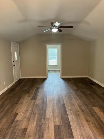 a view of an empty room and window wooden floor