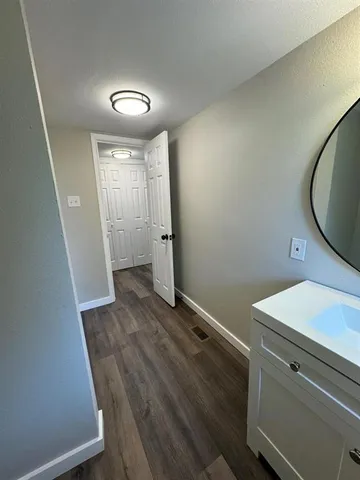 a view of a room with wooden floor and staircase