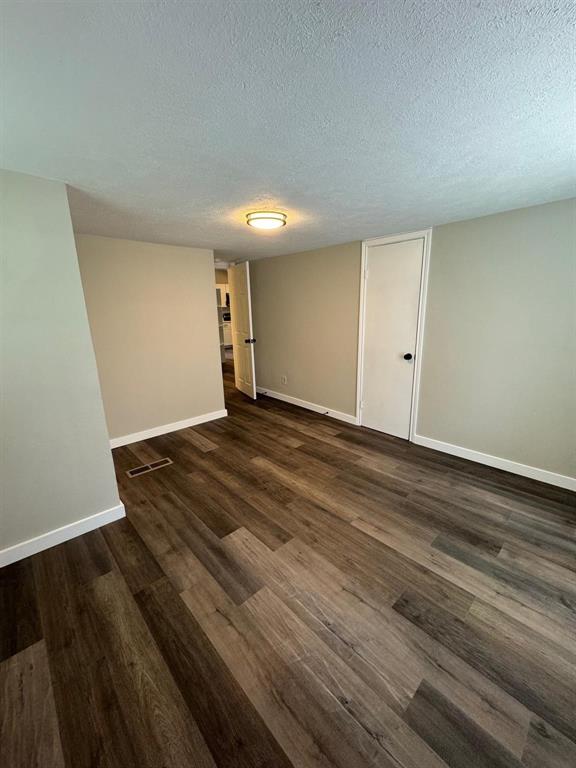 1201 North Rusk Street Weatherford, TX 76086 - Photo 8 of 32 a view of an empty room with wooden floor