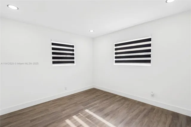 a view of room with wooden floor and window