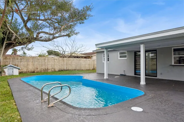 a view of swimming pool with seating space