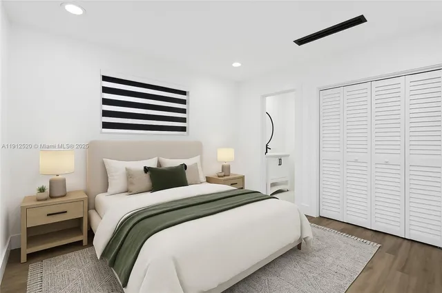 a bedroom with a bed and a night stand