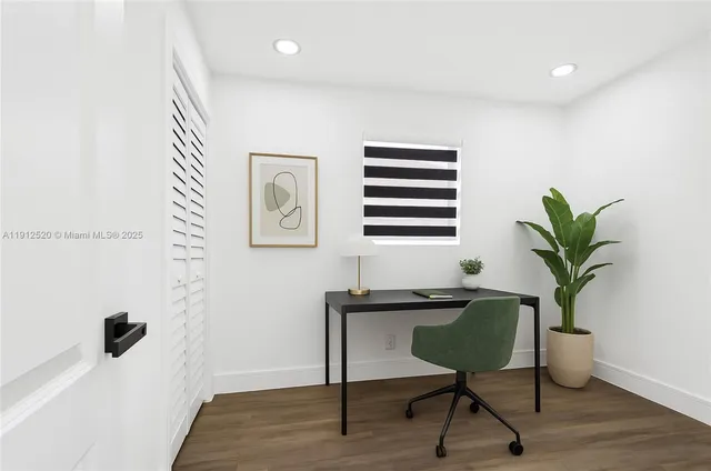 a view of a workspace with furniture and a potted plant