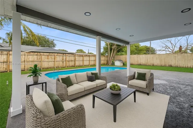 a living room with furniture and a floor to ceiling window