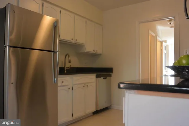 a kitchen with stainless steel appliances a refrigerator and a sink