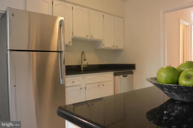 a kitchen with a refrigerator and cabinets