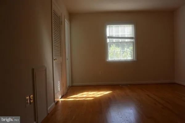 a view of room with hardwood floor and window