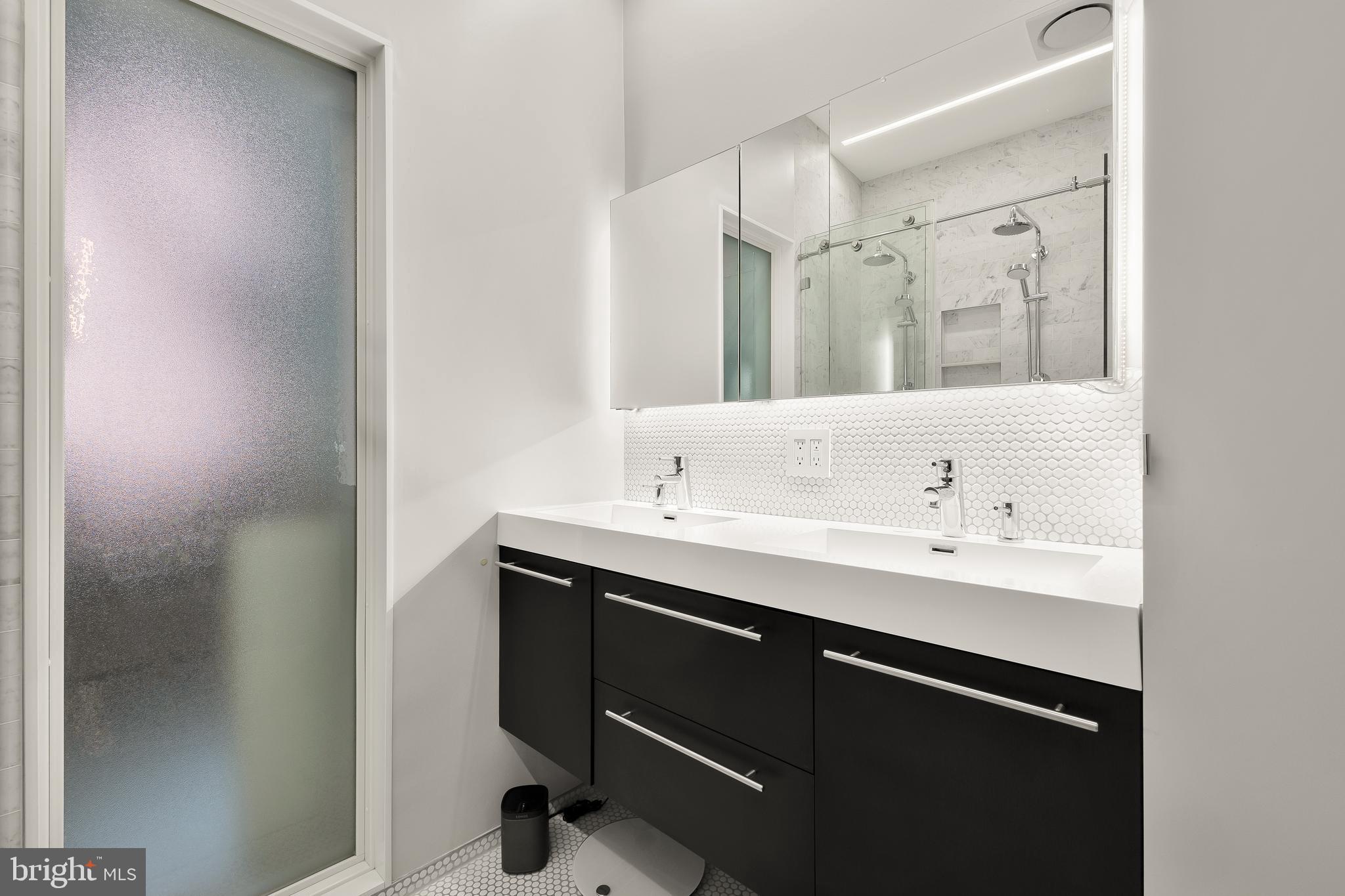 1706 S Street Northwest, Unit 1 Washington, DC 20009 - Photo 24 of 33 a bathroom with a sink and a mirror