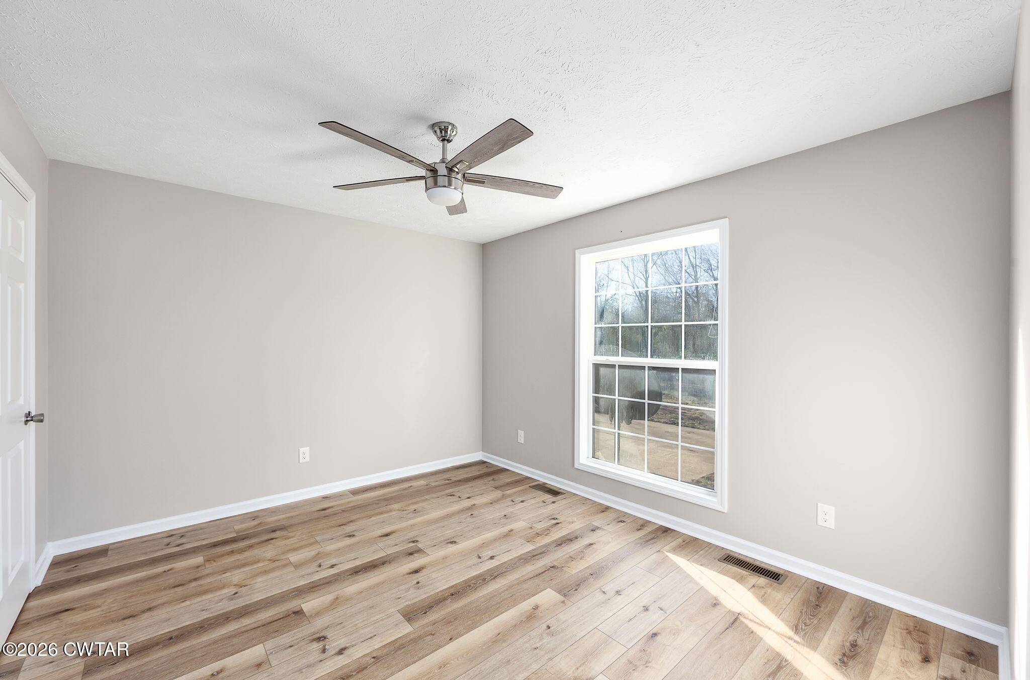 2265 Bond Ferry Road Brownsville, TN 38012 - Photo 12 of 26 a view of a big room with wooden floor and windows in a room
