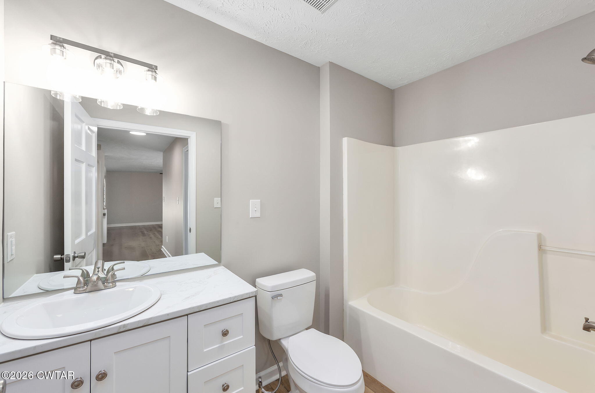 2265 Bond Ferry Road Brownsville, TN 38012 - Photo 16 of 26 a bathroom with a granite countertop sink toilet vanity mirror and bathtub