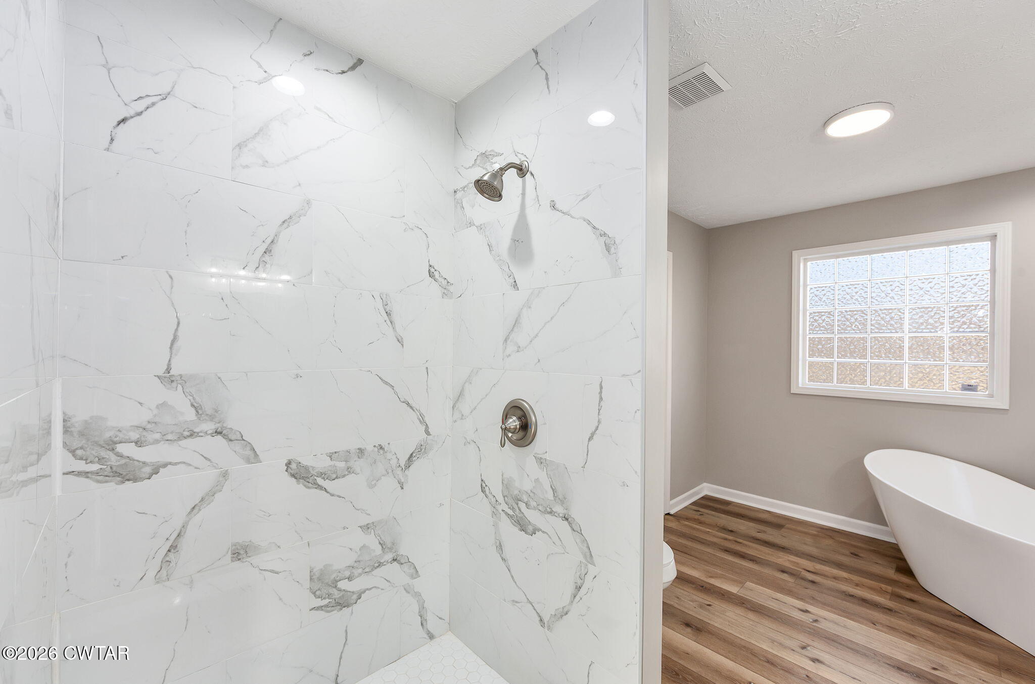 2265 Bond Ferry Road Brownsville, TN 38012 - Photo 17 of 26 a bathroom with a bathtub and shower