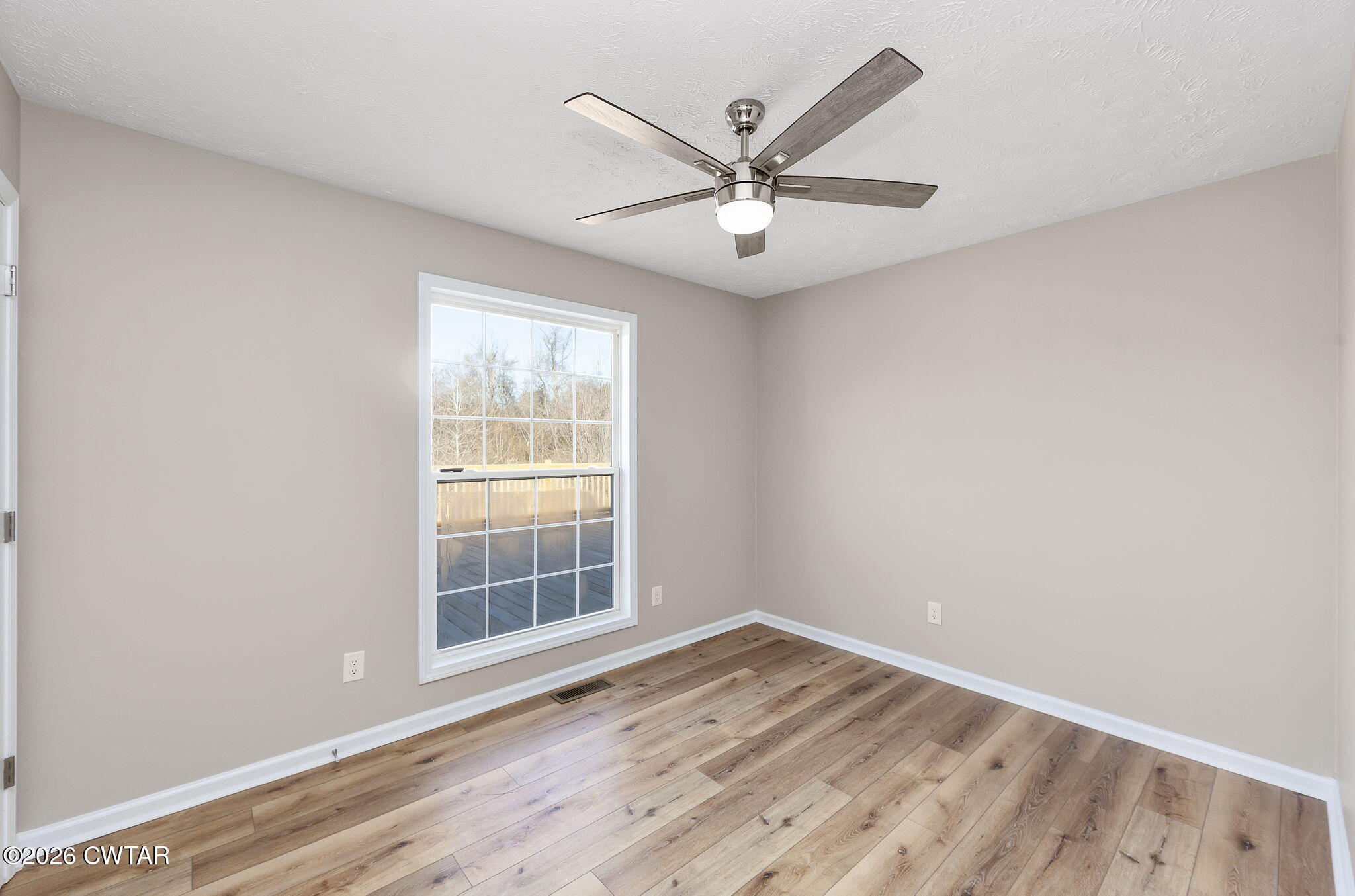 2265 Bond Ferry Road Brownsville, TN 38012 - Photo 18 of 26 an empty room with wooden floor fan and windows
