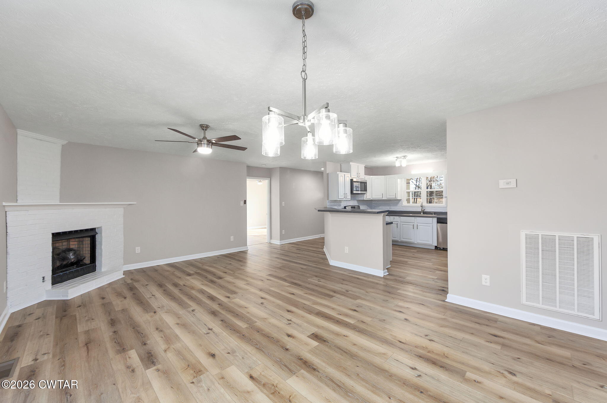 2265 Bond Ferry Road Brownsville, TN 38012 - Photo 20 of 26 a view of a kitchen with granite countertop cabinets and wooden floor